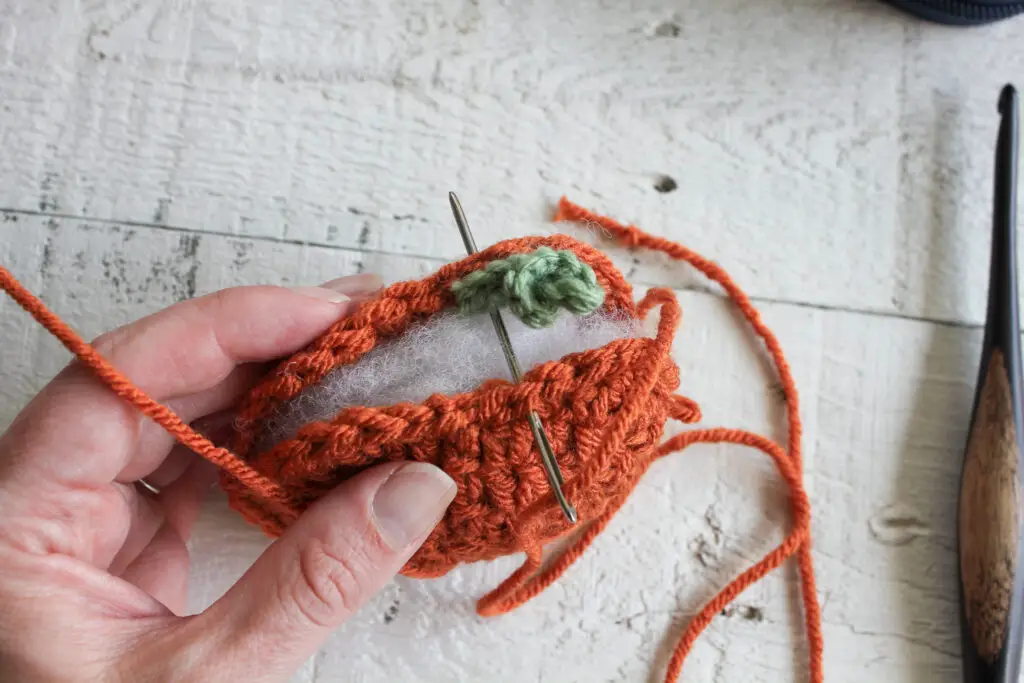Sew through all 3 pieces to attach stem and spiral to the pumpkin body.