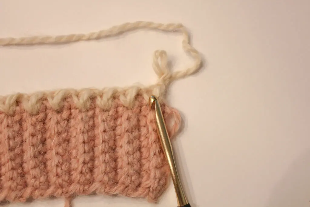 Insert hook into the V of the previous mini bean stitch
