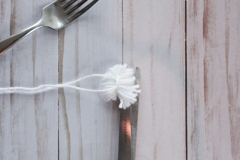 Trim pom pom to shape